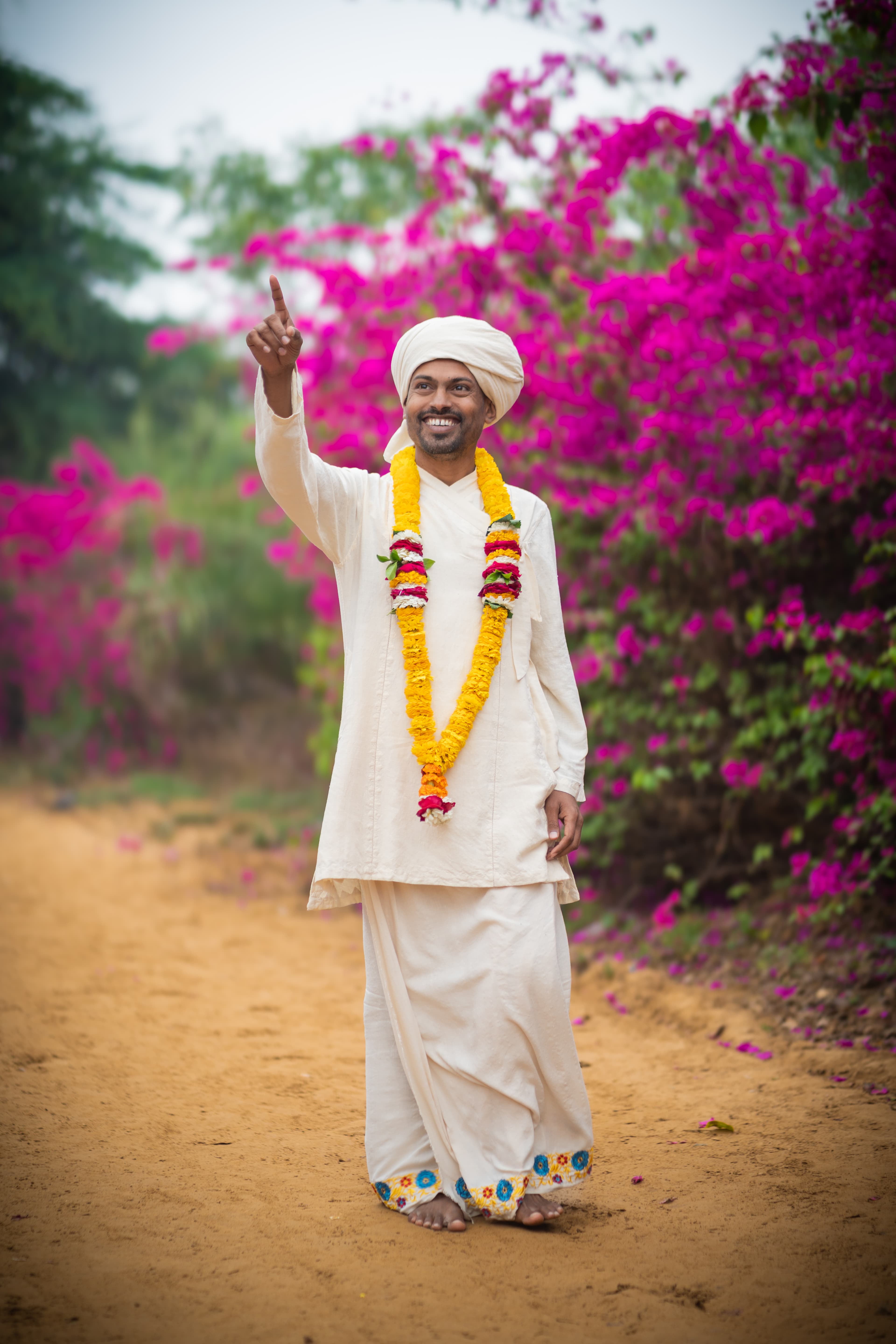 HH Paramguru Ji — spiritual teacher and lineage master, standing serenely among bamboo in Vrindavan
